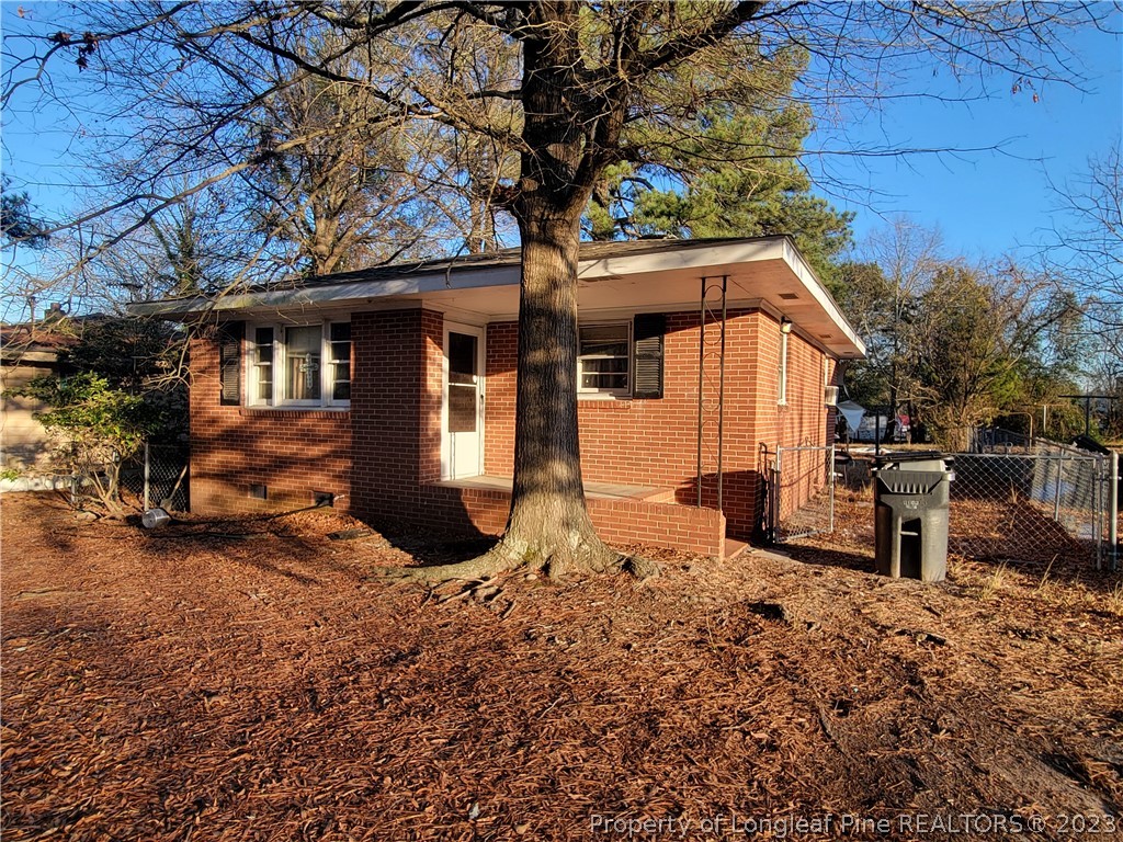 705 Eva Circle Spring Lake, NC 28390 - Photo 2 of 21 a backyard of a house with barbeque oven and outdoor seating