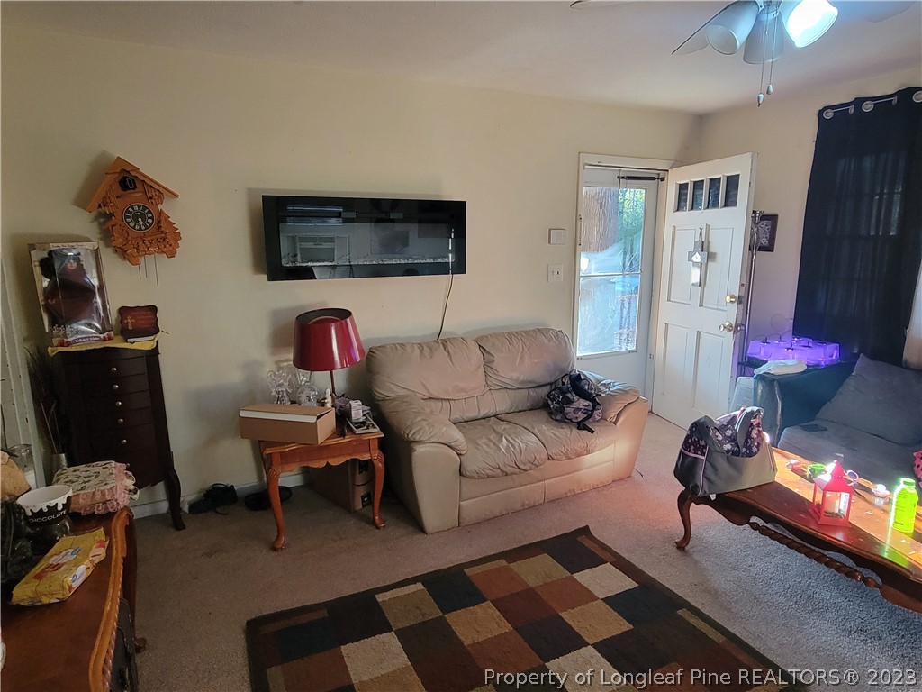 705 Eva Circle Spring Lake, NC 28390 - Photo 5 of 21 a living room with furniture a flat screen tv and a refrigerator