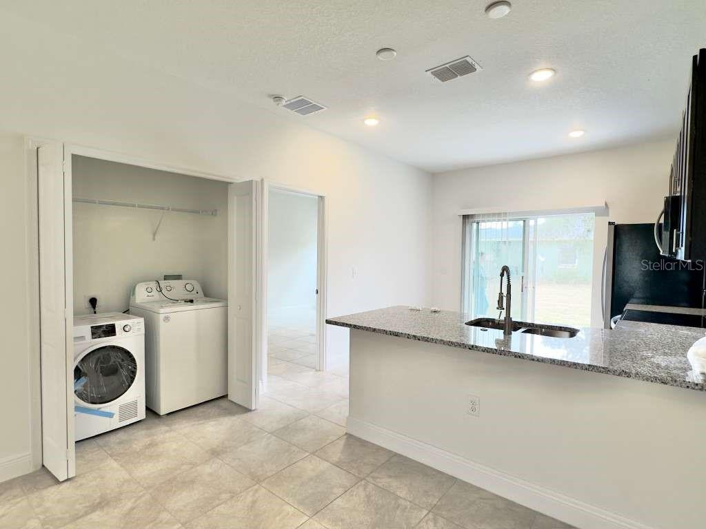 15885 Southwest 35th Court Road, Unit 1 Ocala, FL 34473 - Photo 10 of 27 a view of a storage & utility room with two washing machine