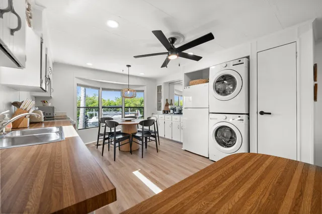 a view of a kitchen with a dining table chairs and a stove