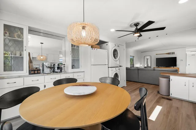 a view of a dining room with furniture and a chandelier