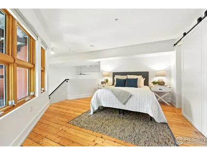 a bedroom with a large bed and a large window