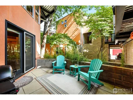 a balcony with table and chairs