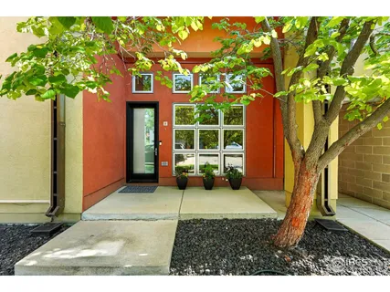 a front view of a house with a tree