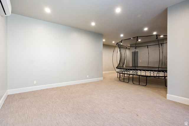 3 Carriagewood Cove, Unit 1088 Sandy, UT 84092 - Photo 61 of 79 Spacious room featuring light-colored carpet, recessed ceiling lighting, and a mini-split air conditioning unit