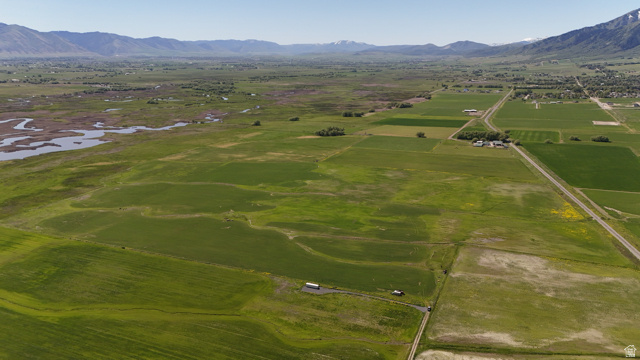 320 South 5400 West Logan, UT 84321 - Photo 5 of 42 Expansive agricultural land featuring diverse green fields and distant mountain ranges