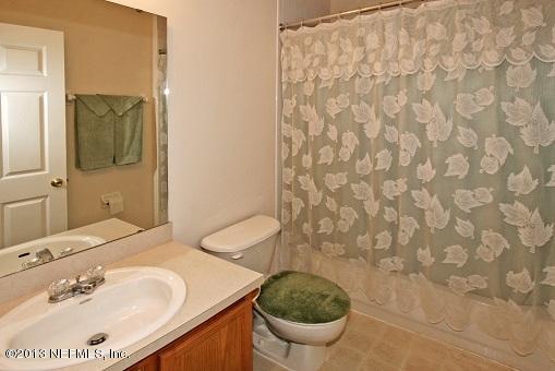 1825 Keswick Road St. Augustine, FL 32084 - Photo 19 of 19 a bathroom with a sink a toilet and a mirror