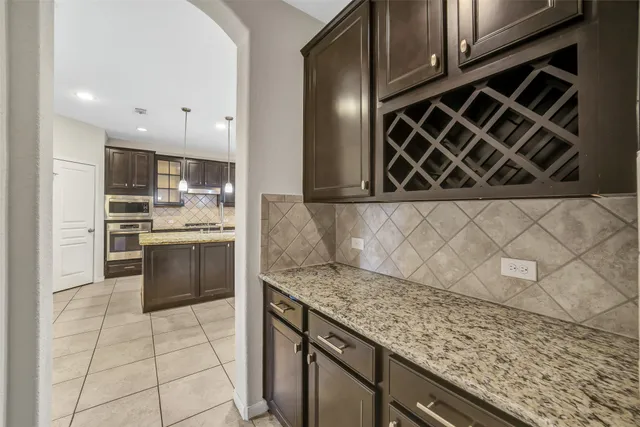 a kitchen with a stove a microwave and a refrigerator