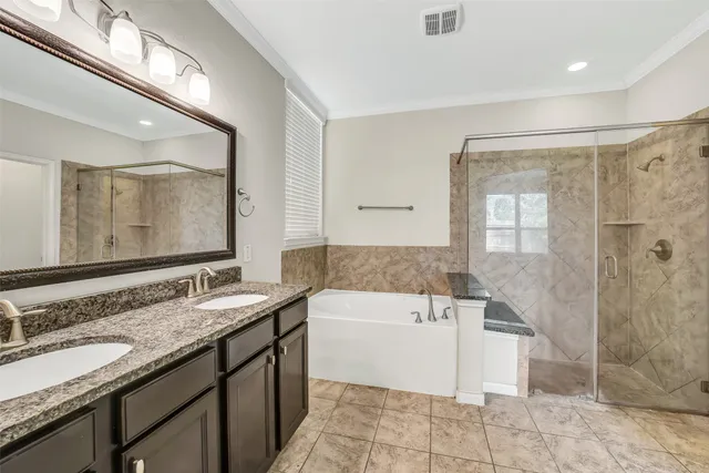 a bathroom with a granite countertop sink mirror and bathtub