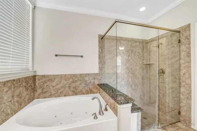 a bathroom with a tub and shower