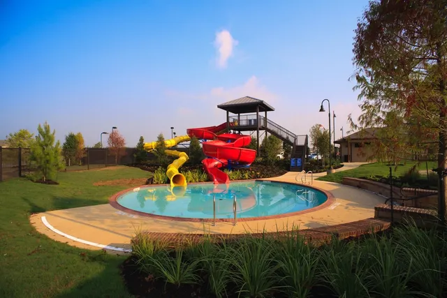 a view of a swimming pool with a yard