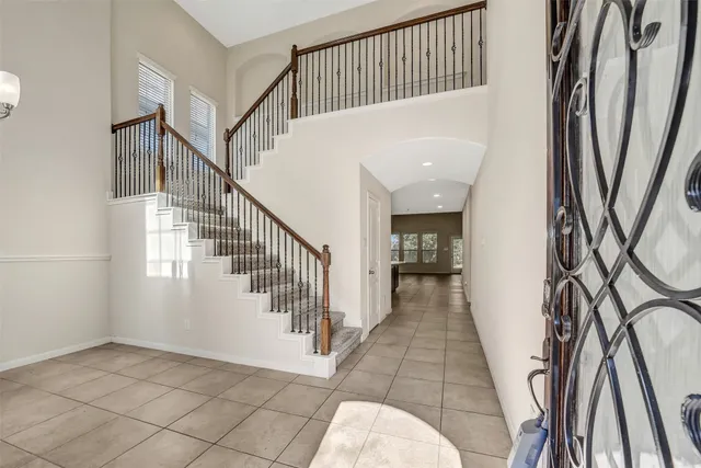 a view of a hallway with wooden floor and entryway