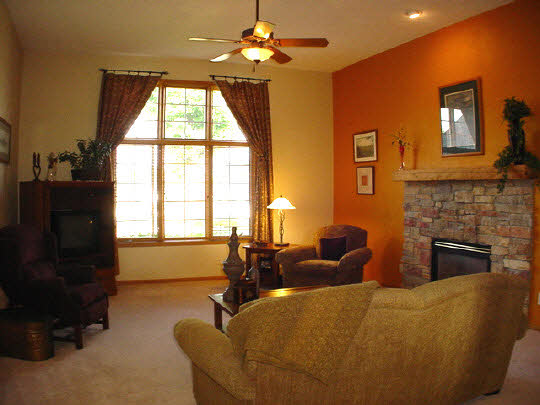9845 Rambouillet Ridge Roscoe, IL 61073 - Photo 3 of 11 a living room with couches a fireplace and a flat screen tv