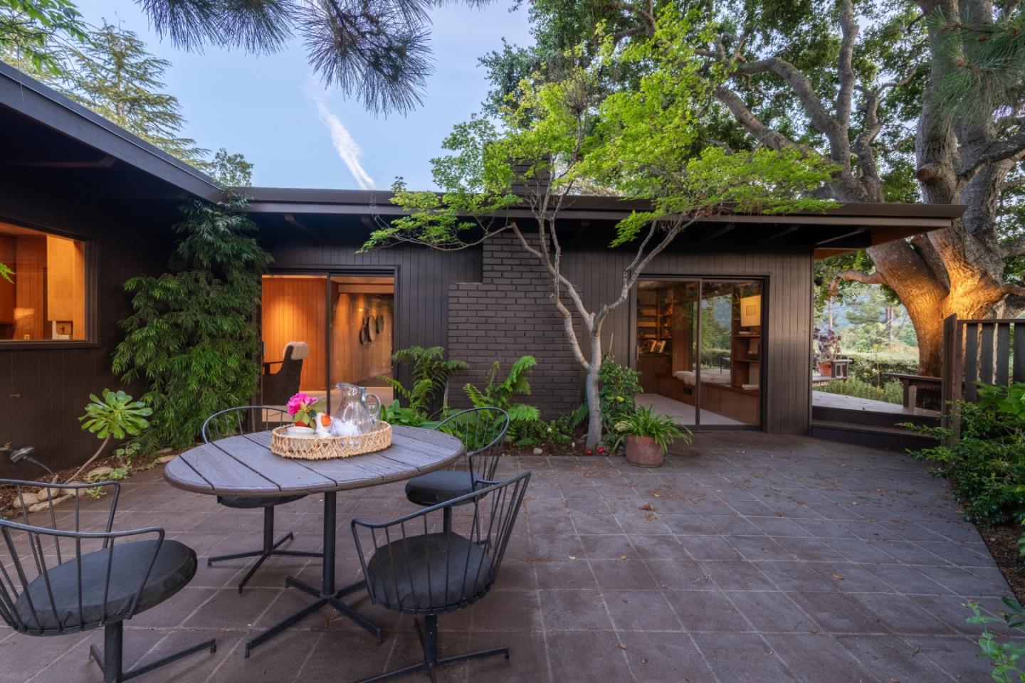 46 Middle Canyon Road Carmel Valley, CA 93924 - Photo 55 of 74 a view of a chair and table in backyard of the house