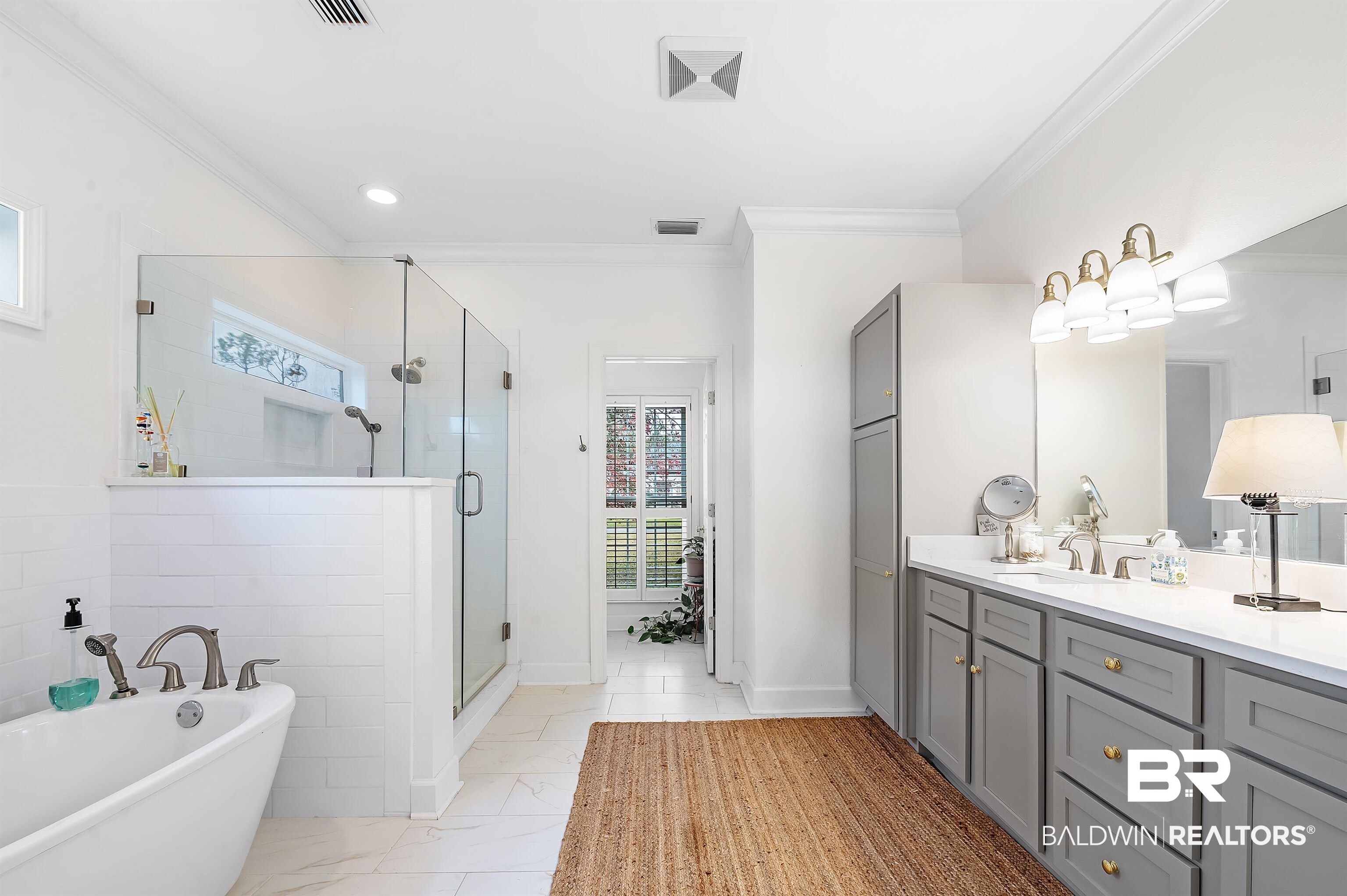 8915 Bay Point Drive Elberta, AL 36530 - Photo 53 of 74 Bathroom featuring a stall shower, ornamental molding, a freestanding bath, and vanity