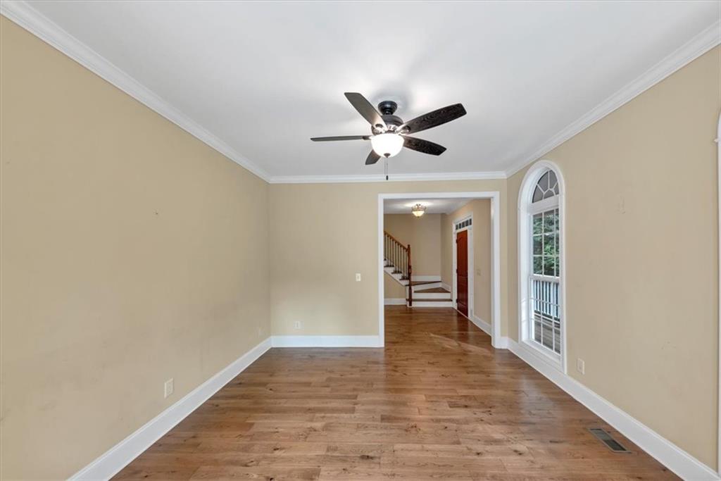231 Beaver Ridge Road Jasper, GA 30143 - Photo 16 of 80 a view of a hallway with wooden floor and a ceiling fan