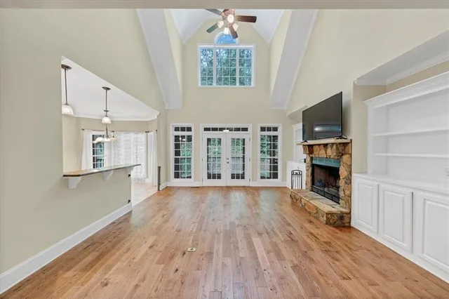 a bathroom with a toilet a sink a mirror a window and vanity