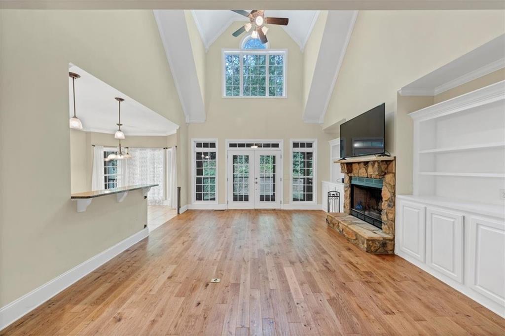 231 Beaver Ridge Road Jasper, GA 30143 - Photo 19 of 80 an empty room with fireplace wooden floor and windows
