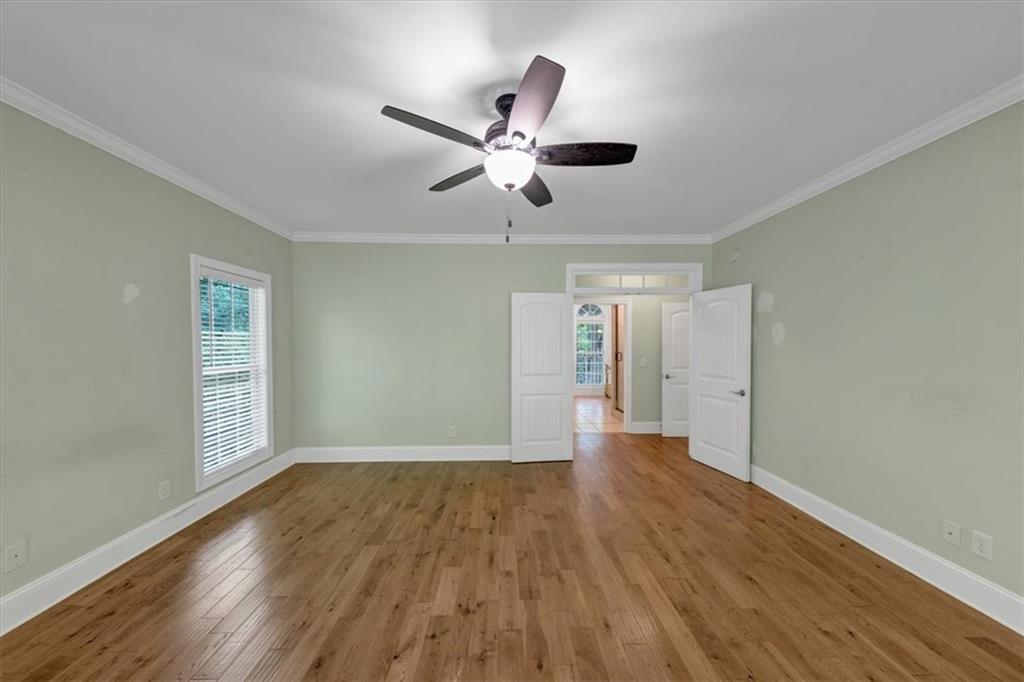 231 Beaver Ridge Road Jasper, GA 30143 - Photo 31 of 80 a view of an empty room with wooden floor and a window