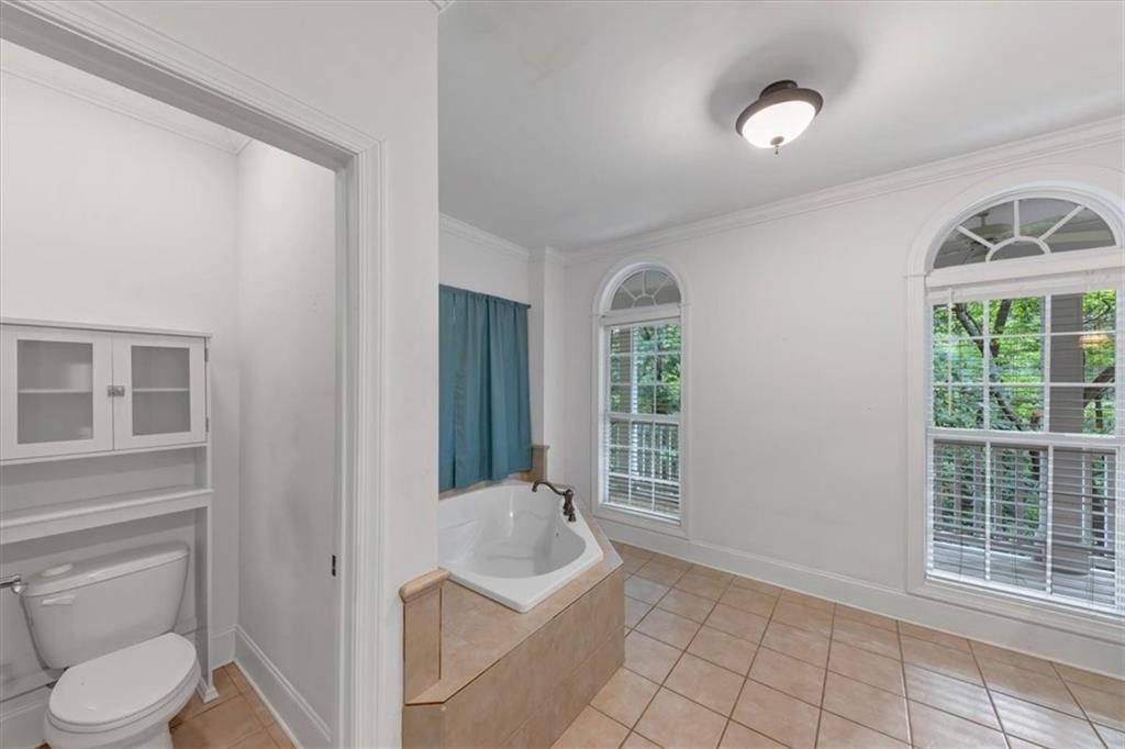 231 Beaver Ridge Road Jasper, GA 30143 - Photo 33 of 80 a bathroom with a toilet a sink a mirror a window and vanity