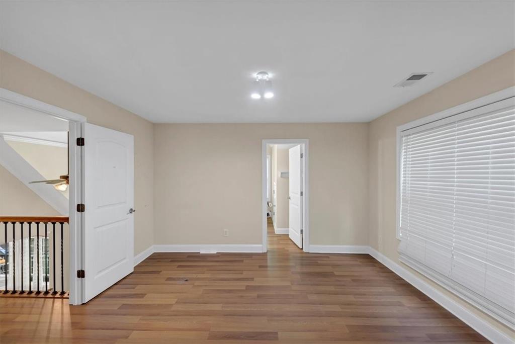 231 Beaver Ridge Road Jasper, GA 30143 - Photo 41 of 80 a view of an empty room with wooden floor and a window