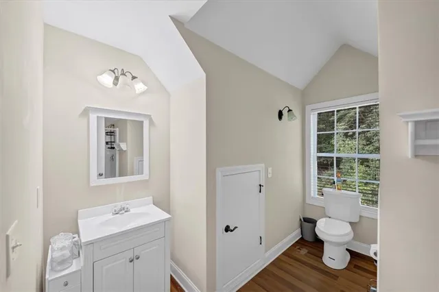 a view of a house with a yard and large trees