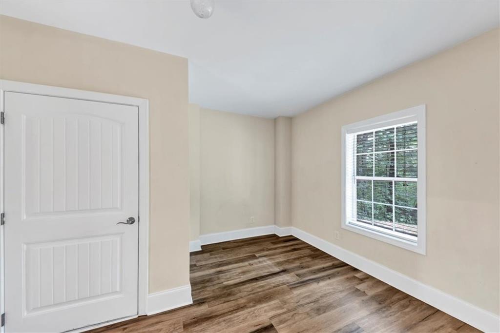 231 Beaver Ridge Road Jasper, GA 30143 - Photo 57 of 80 an empty room with wooden floor and windows