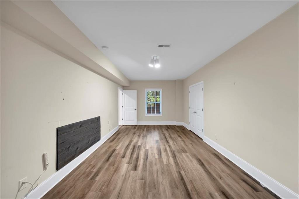 231 Beaver Ridge Road Jasper, GA 30143 - Photo 62 of 80 a view of an empty room with wooden floor and a window