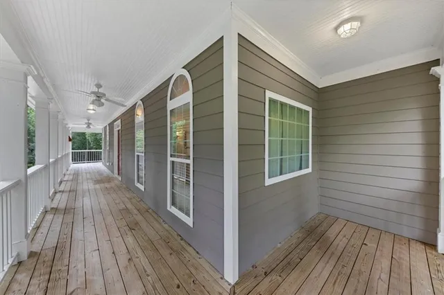 an empty room with fireplace wooden floor and windows
