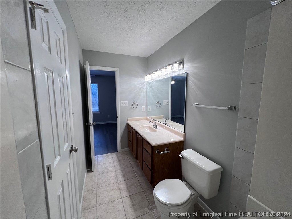 3375 Galleria Drive, Unit 17 Fayetteville, NC 28303 - Photo 12 of 19 a bathroom with a toilet sink and mirror