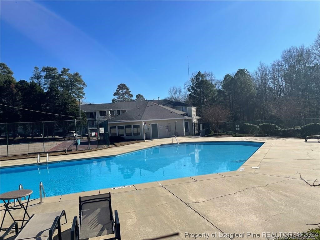 3375 Galleria Drive, Unit 17 Fayetteville, NC 28303 - Photo 18 of 19 a view of a swimming pool with a lounge chair
