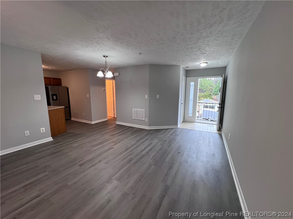 3375 Galleria Drive, Unit 17 Fayetteville, NC 28303 - Photo 2 of 19 an empty room with wooden floor and windows