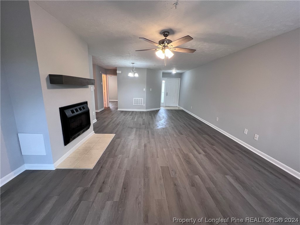 3375 Galleria Drive, Unit 17 Fayetteville, NC 28303 - Photo 4 of 19 a view of an empty room with wooden floor and fireplace
