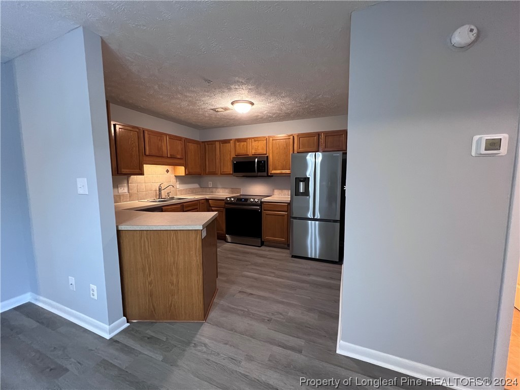 3375 Galleria Drive, Unit 17 Fayetteville, NC 28303 - Photo 6 of 19 a kitchen with stainless steel appliances granite countertop a refrigerator a stove a sink and a microwave