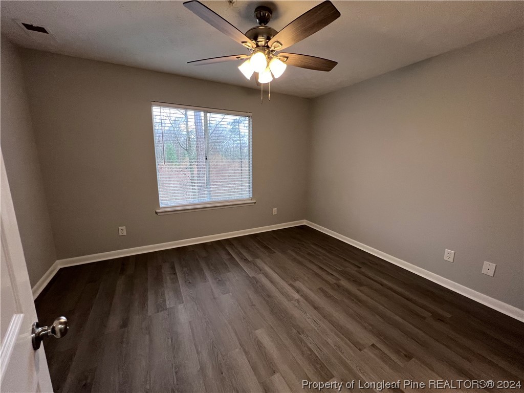 3375 Galleria Drive, Unit 17 Fayetteville, NC 28303 - Photo 9 of 19 wooden floor in an empty room with a window