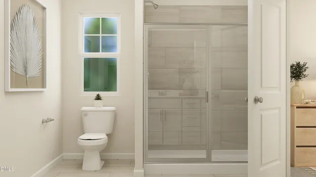 a bathroom with a toilet and a shower