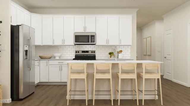 a white kitchen with stainless steel appliances granite countertop white cabinets a sink and a refrigerator