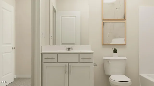 a bathroom with a sink toilet and mirror