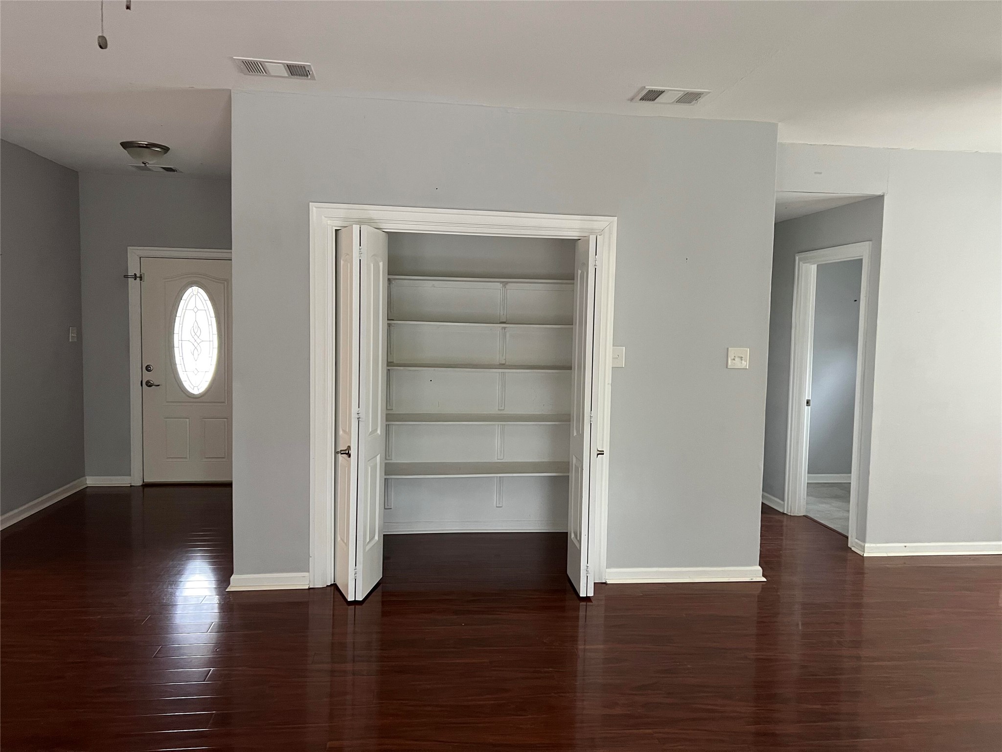 239 Old Firetower Road Bastrop, TX 78602 - Photo 8 of 39 closet opening into living for storage, etc. with shelving