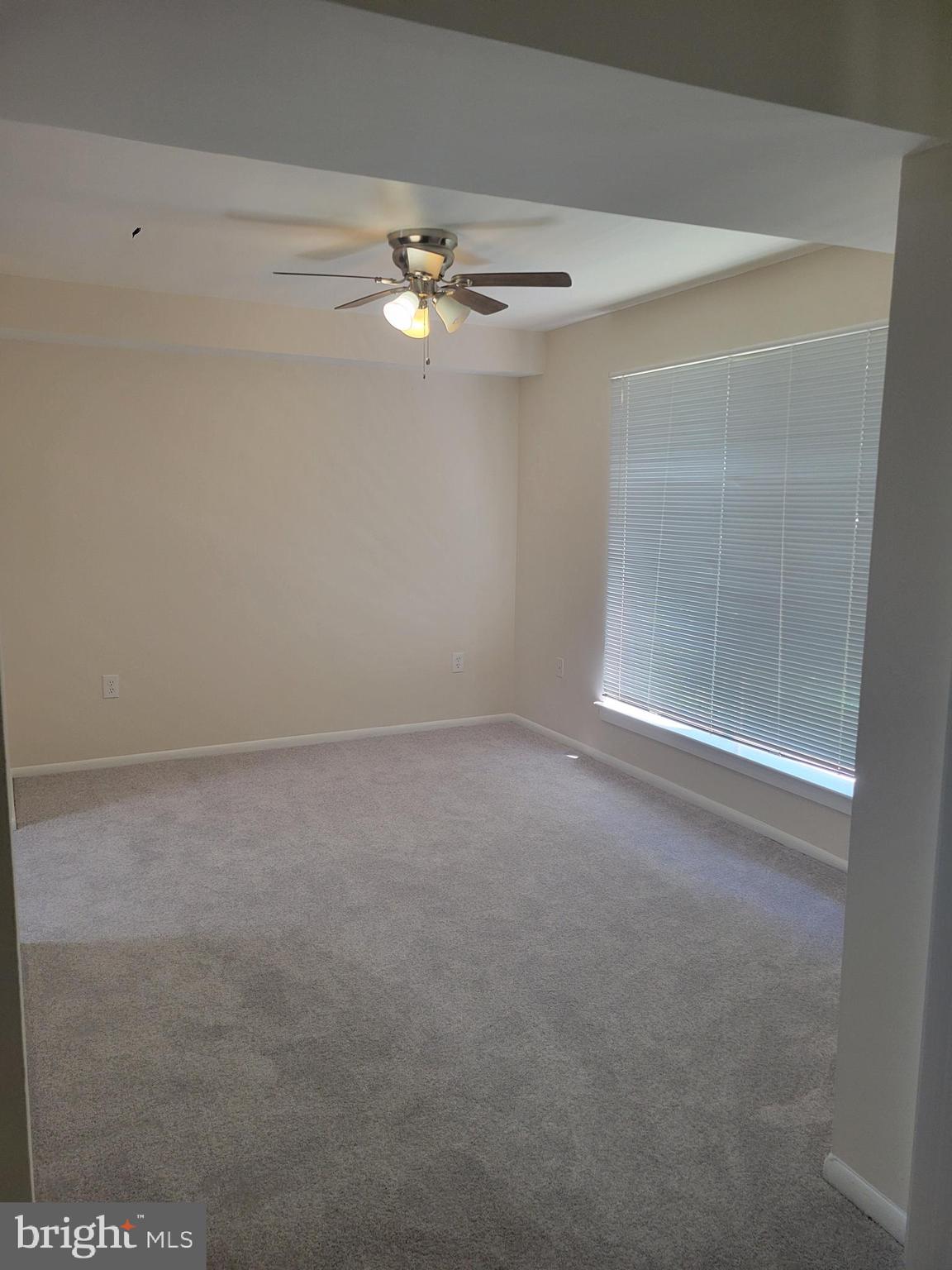 8431 Greenbelt Road Greenbelt, MD 20770 - Photo 8 of 16 en empty room with windows and chandelier fan