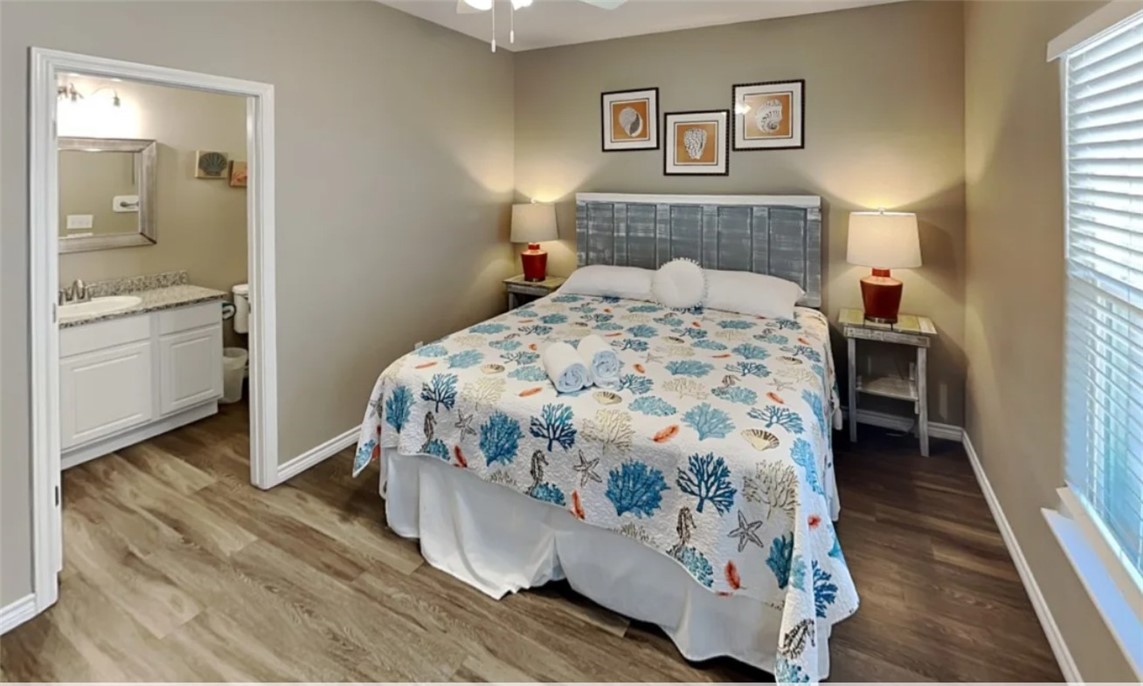 14916 Packery View Loop Corpus Christi, TX 78418 - Photo 11 of 32 a bedroom with a bed and a lamp on dresser