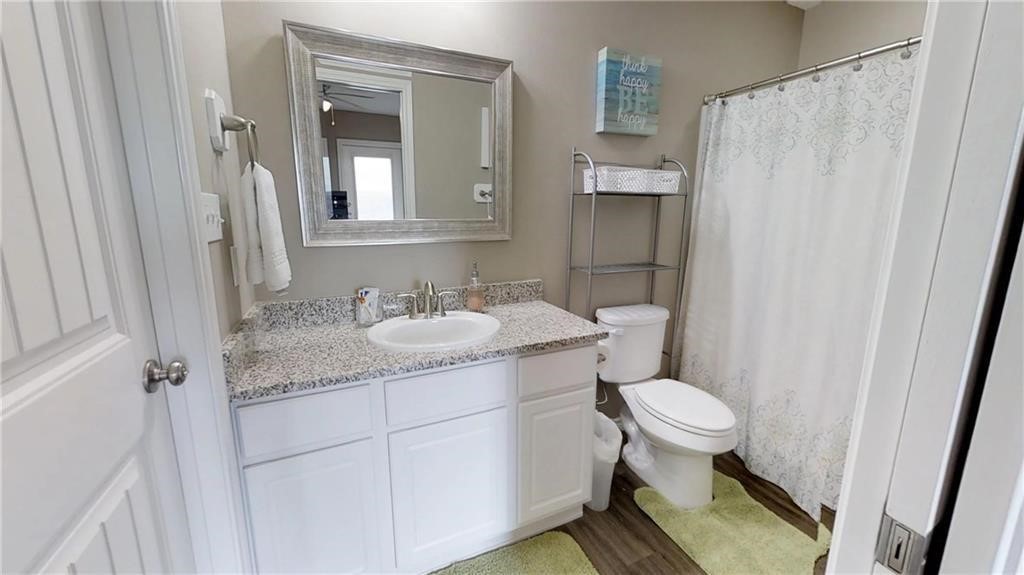14916 Packery View Loop Corpus Christi, TX 78418 - Photo 12 of 32 a bathroom with a granite countertop sink toilet and shower