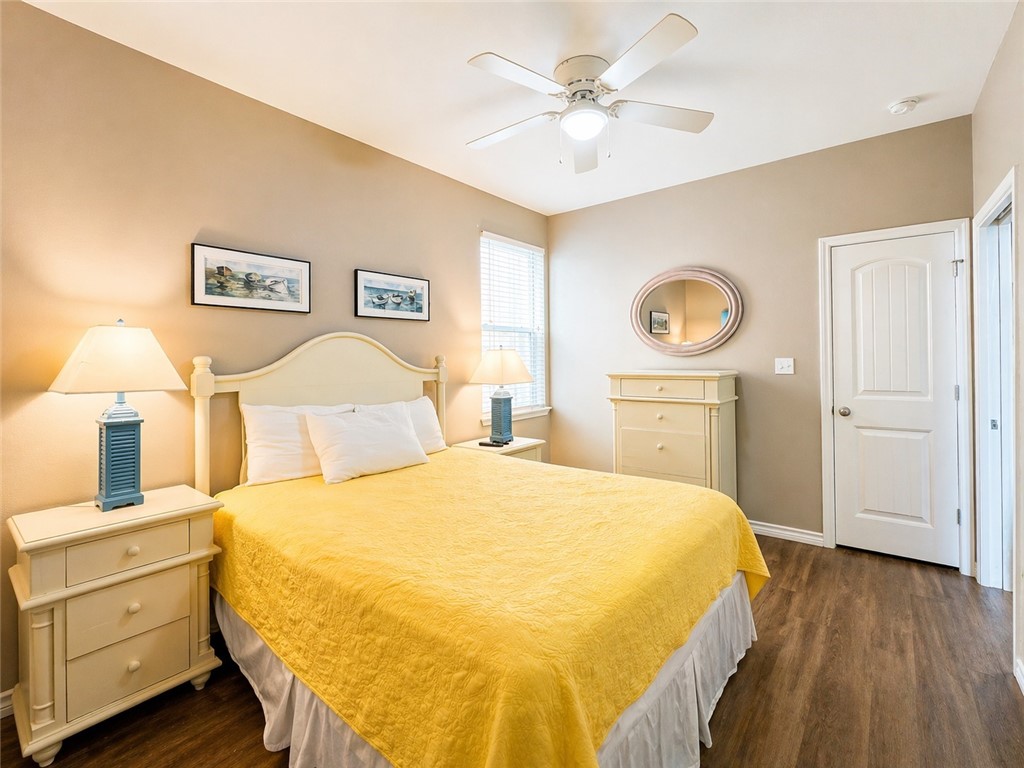 14916 Packery View Loop Corpus Christi, TX 78418 - Photo 13 of 32 a bedroom with a bed and a chandelier