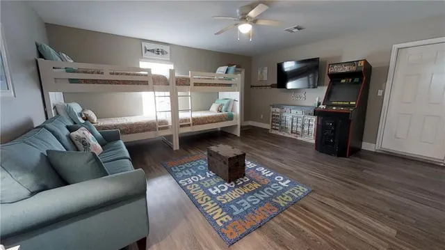 a living room with furniture and wooden floor