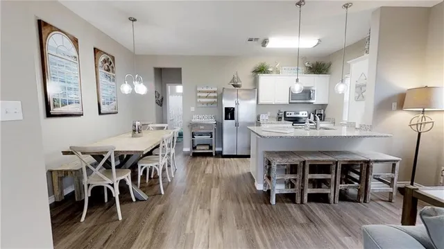 a view of a dining room with furniture and wooden floor