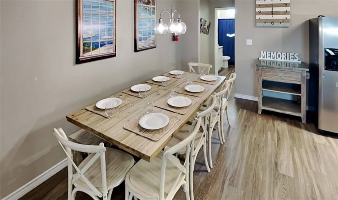 14916 Packery View Loop Corpus Christi, TX 78418 - Photo 6 of 32 a view of a dining room with furniture and wooden floor