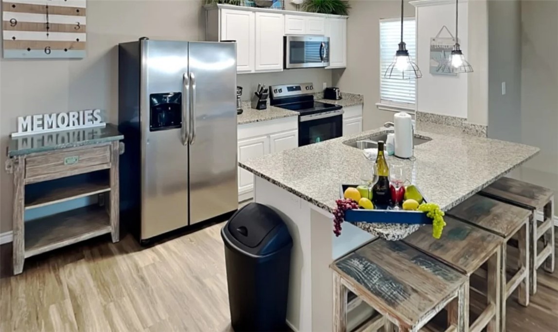 14916 Packery View Loop Corpus Christi, TX 78418 - Photo 7 of 32 a kitchen with stainless steel appliances granite countertop a refrigerator a stove and a sink