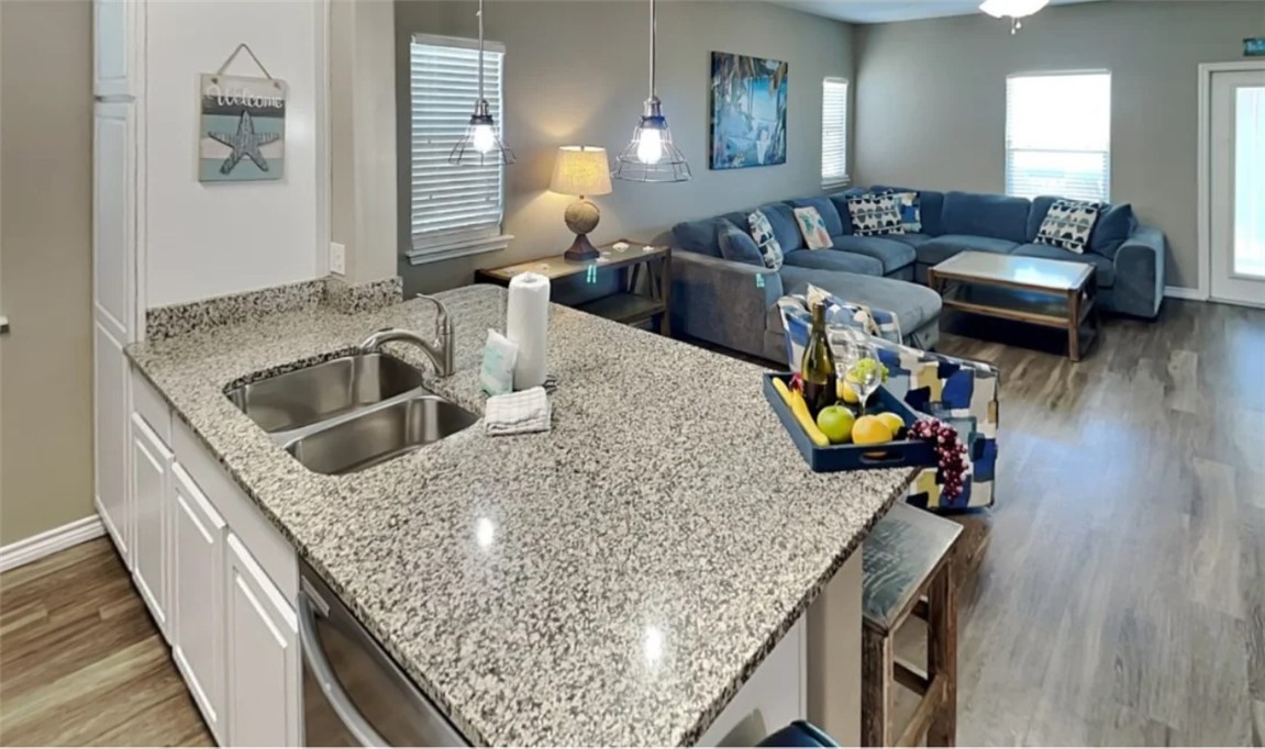 14916 Packery View Loop Corpus Christi, TX 78418 - Photo 8 of 32 a kitchen with stainless steel appliances granite countertop a sink a stove and a wooden floors
