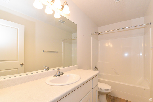1632 North Apache Road Saratoga Springs, UT 84045 - Photo 23 of 28 Bathroom featuring a white vanity with an integrated sink, polished chrome faucet, and overhead vanity lighting