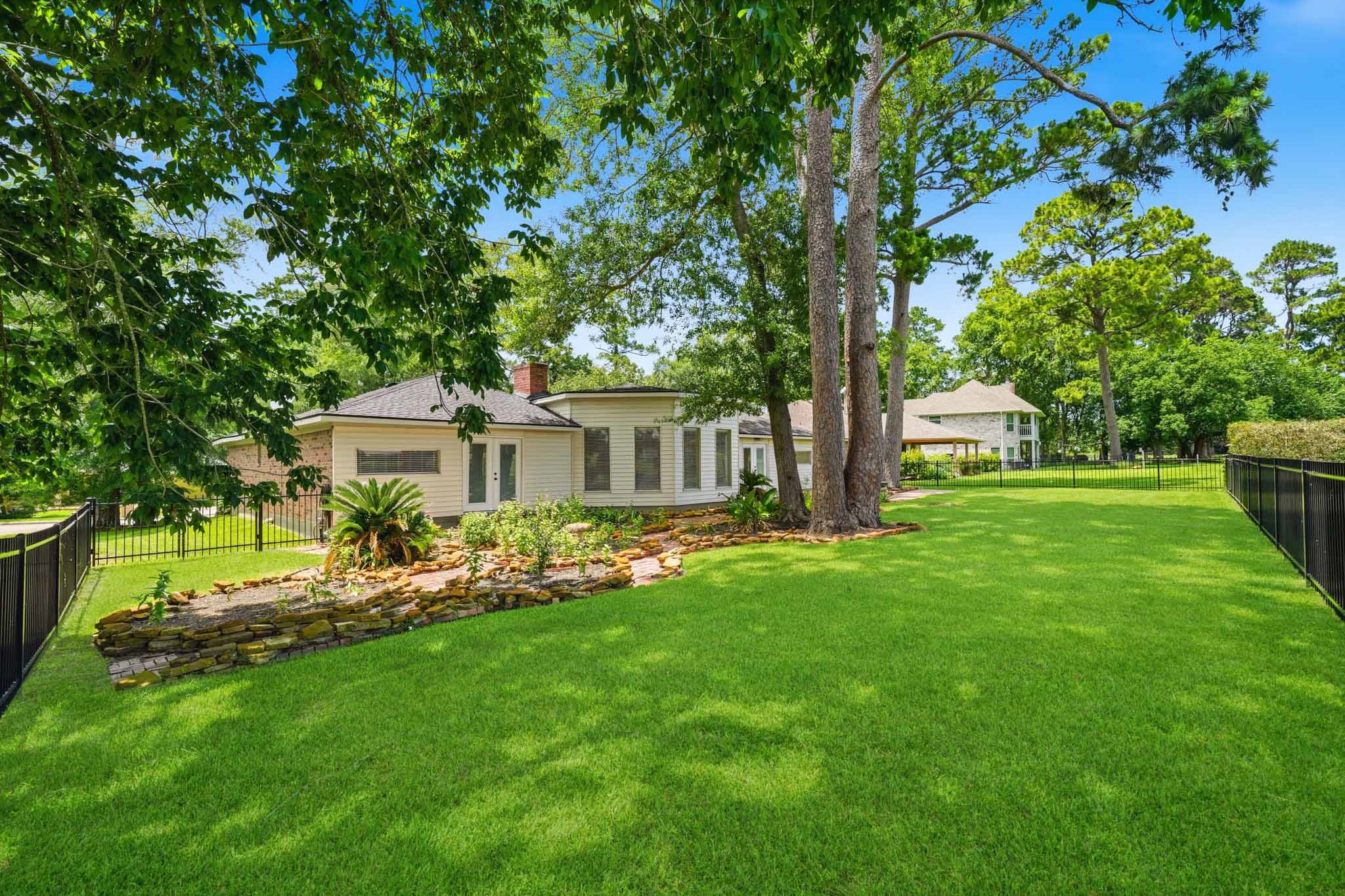 79 Summers Wind Street Conroe, TX 77356 - Photo 34 of 45 a front view of a house with garden